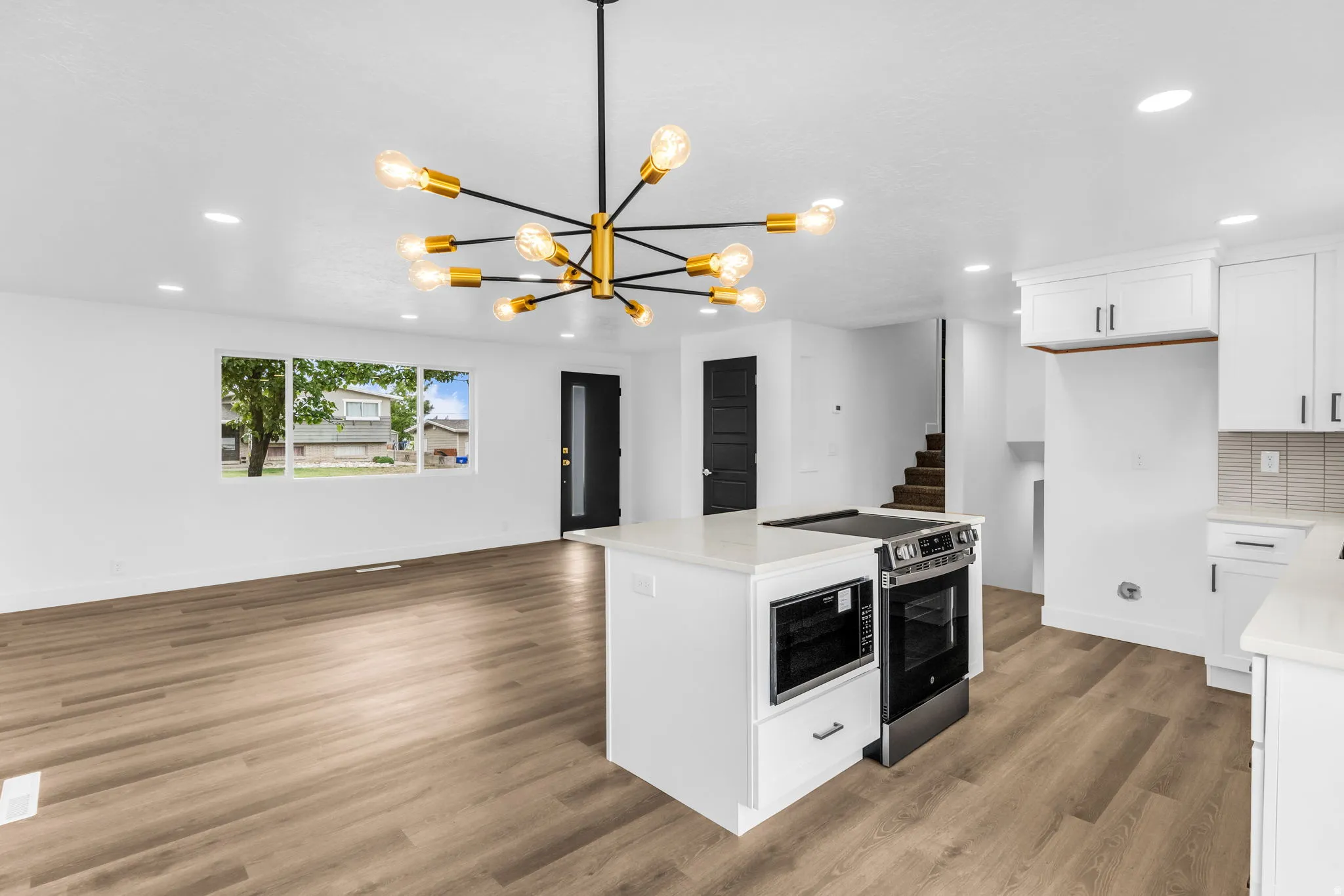 Open-concept living space with wood-finish flooring