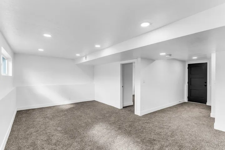 Expansive room featuring recessed lighting, a window, and plush carpeting