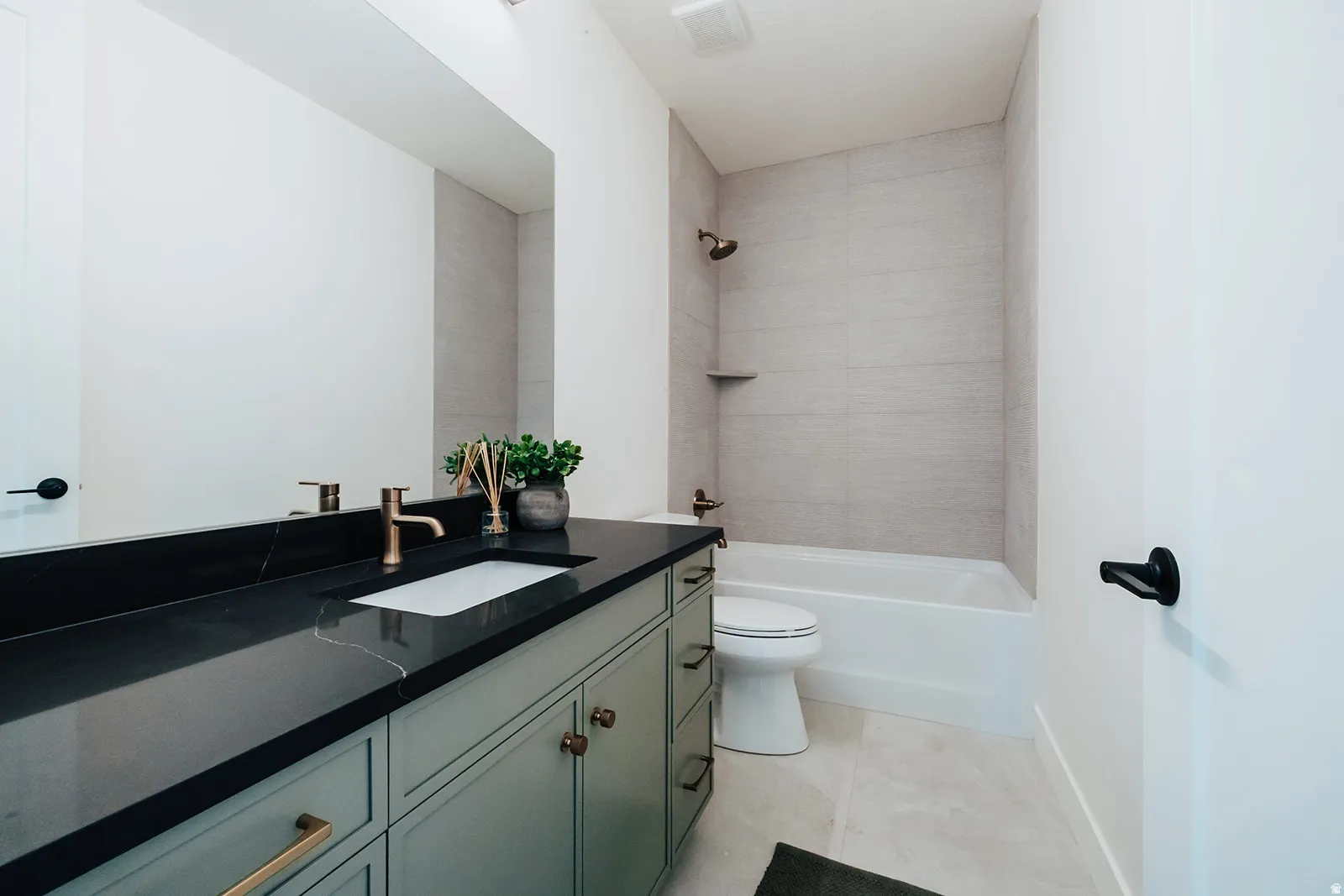 Light-toned tile flooring complements the white soaking tub and toilet