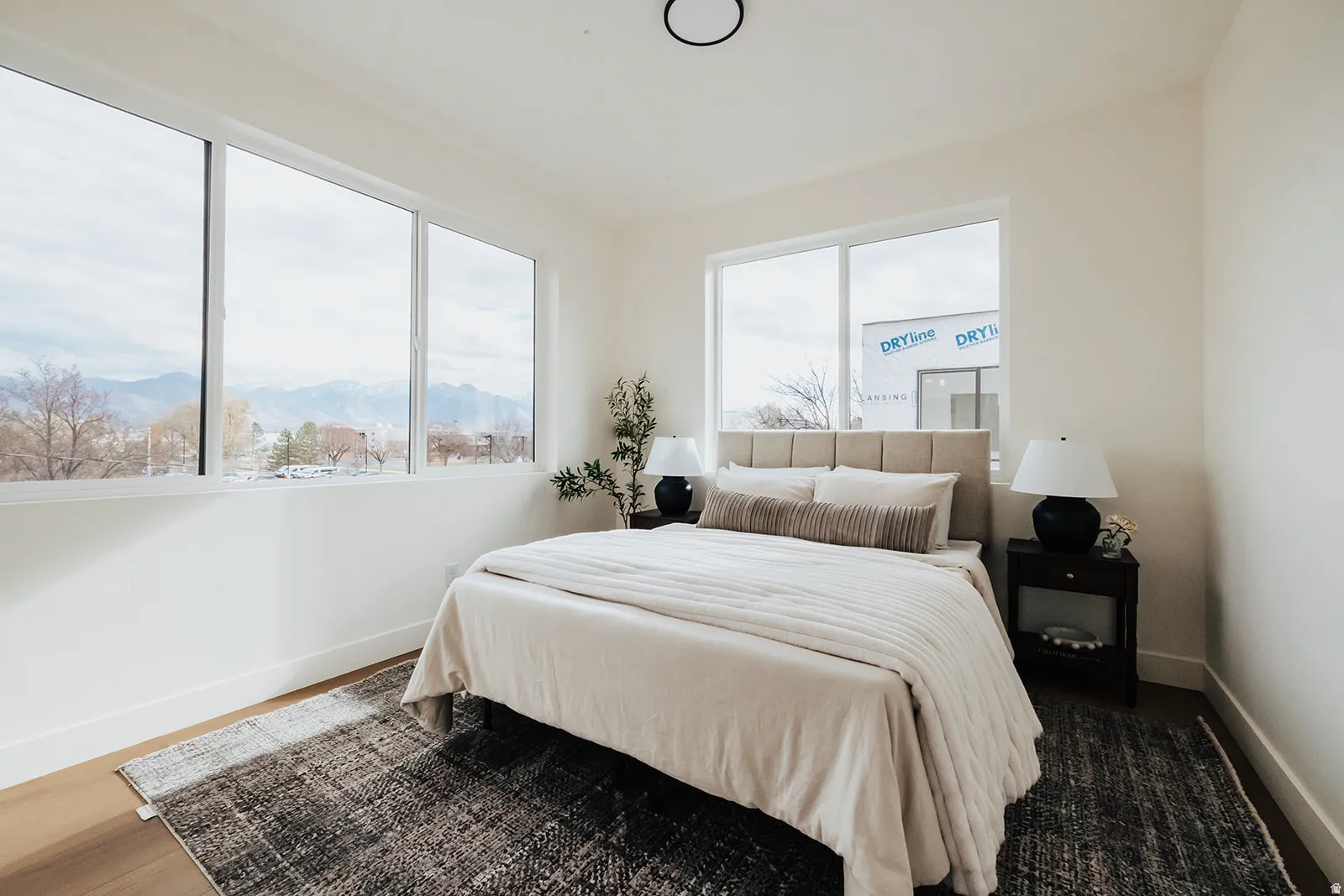 Expansive windows, wood-finish flooring, and light-toned walls