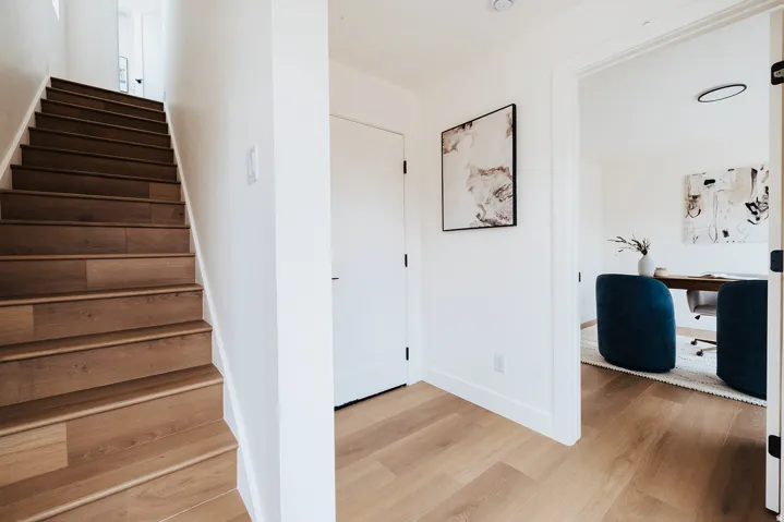 Wood-finish flooring throughout, white walls, and a recessed ceiling light