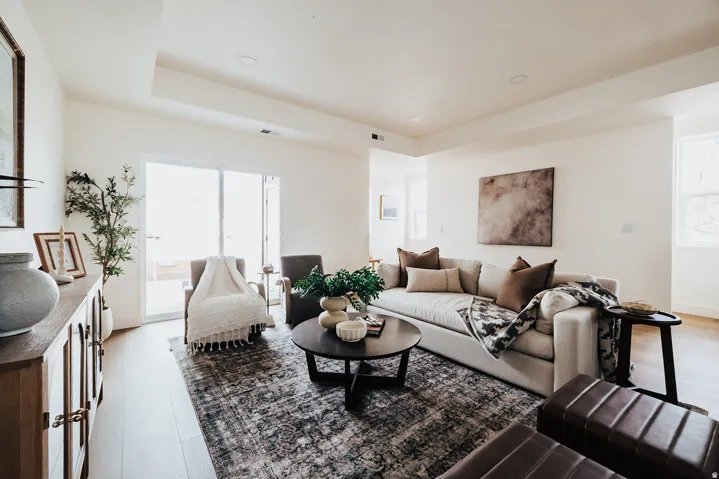 Recessed lighting, wood-finish flooring, sliding glass door, and a built-in wall niche