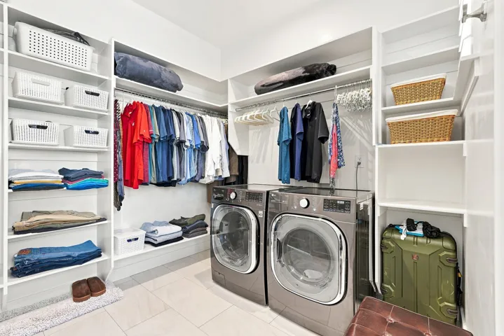 Dedicated laundry inside master closet.