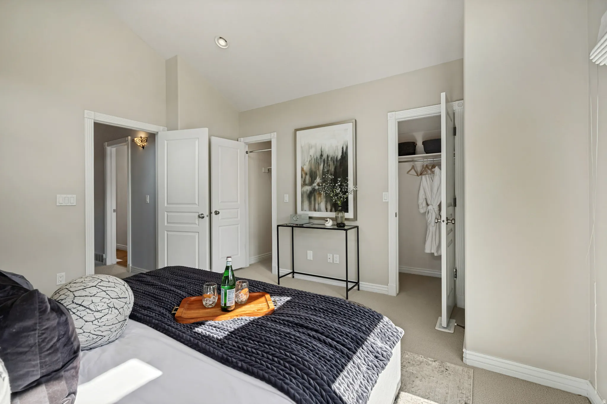 Vaulted ceiling, recessed lighting, double closet doors, and built-in closet shelving