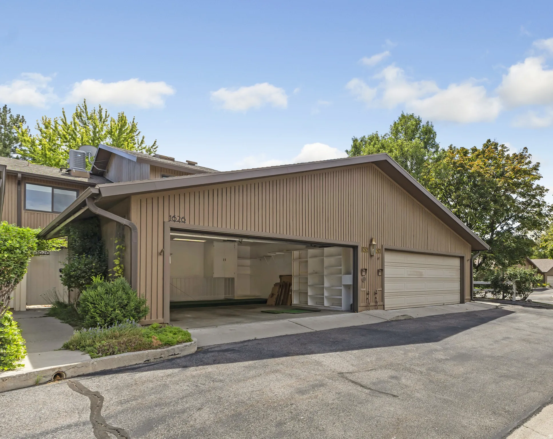 Expansive garage with an overhead door and integrated shelving