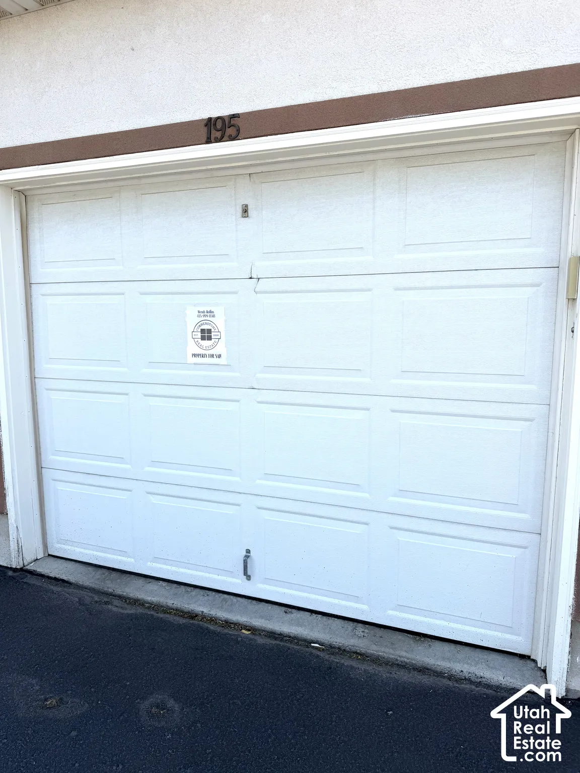 White paneled garage door with address numbers