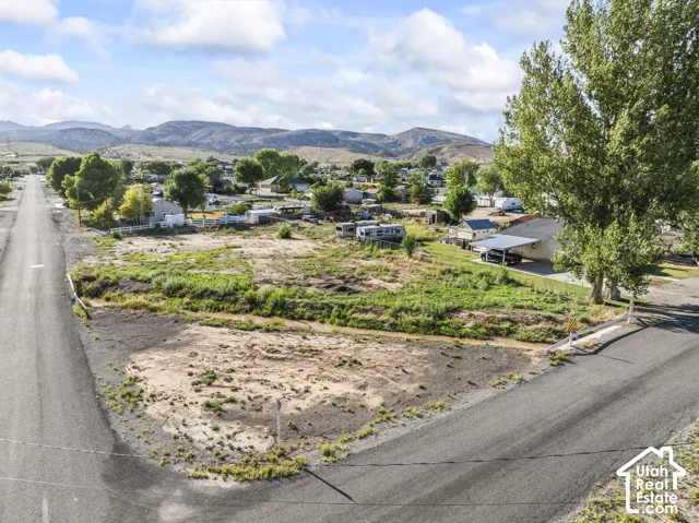 Expansive undeveloped lot featuring natural vegetation, surrounded by paved roads