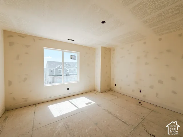 White-framed window, textured ceiling, and unfinished walls