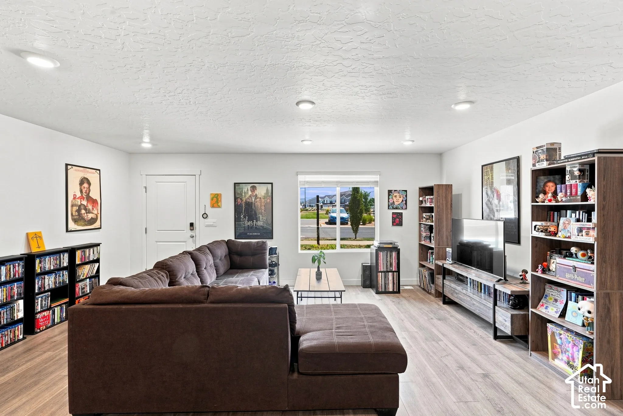 Recessed lighting, wood-finish flooring, and white walls
