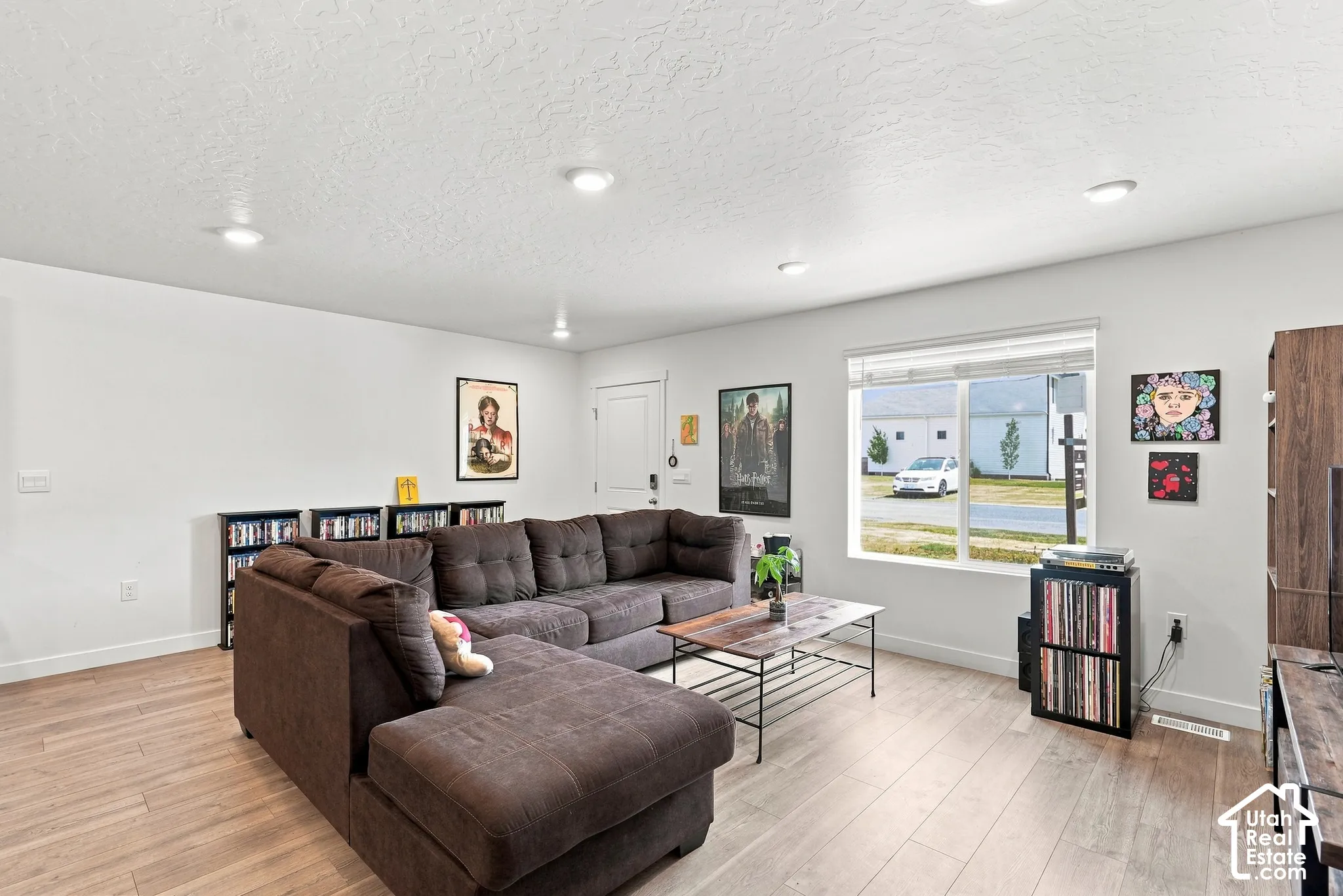 Recessed ceiling lighting, wood-finish flooring, and a large window
