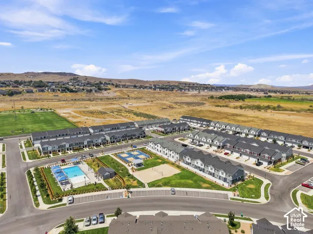Community featuring a swimming pool, sports courts, and a manicured green space