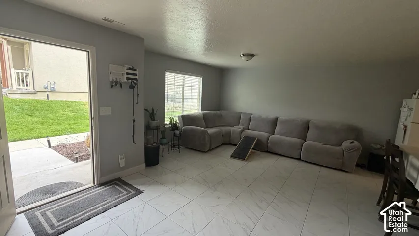 Entryway with white door and white tile flooring