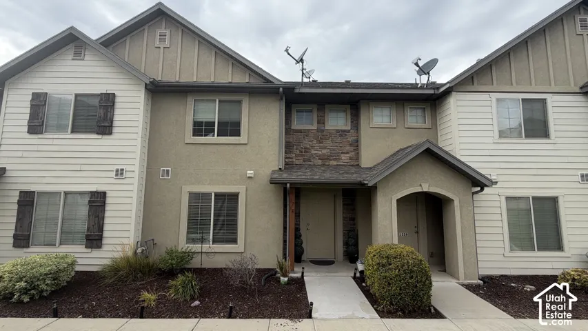 Multi-level facade with siding and stucco finishes