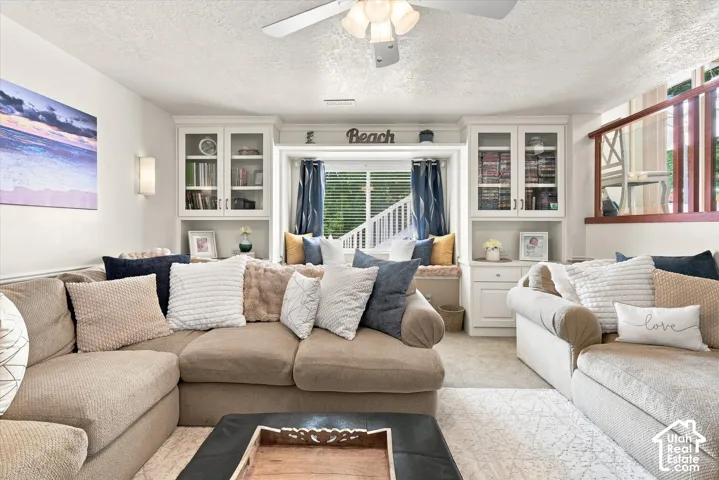 Built-in cabinetry with glass-front uppers and lower storage, integrated window seat, and recessed lighting