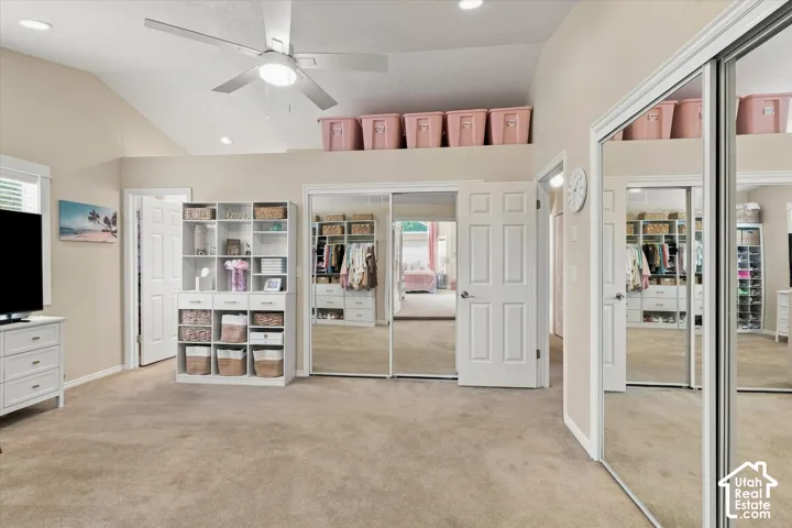 Vaulted ceiling with recessed lighting and ceiling fan