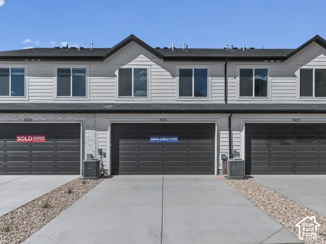 Light gray horizontal siding with dark gray garage doors