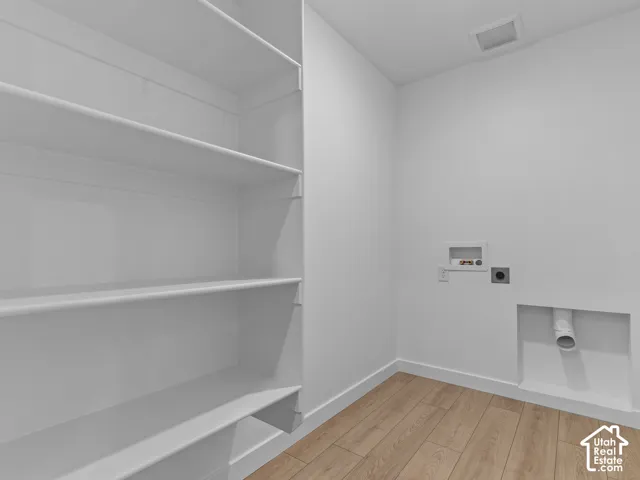 Built-in shelving, wood-finish flooring, and white walls