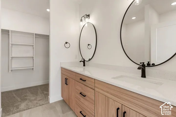 Double vanity with integrated sinks and white countertops