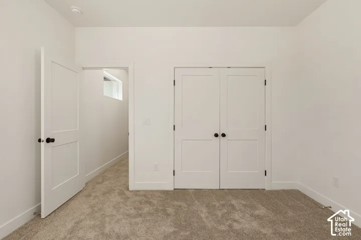 Neutral-toned carpet flooring with white walls and trim