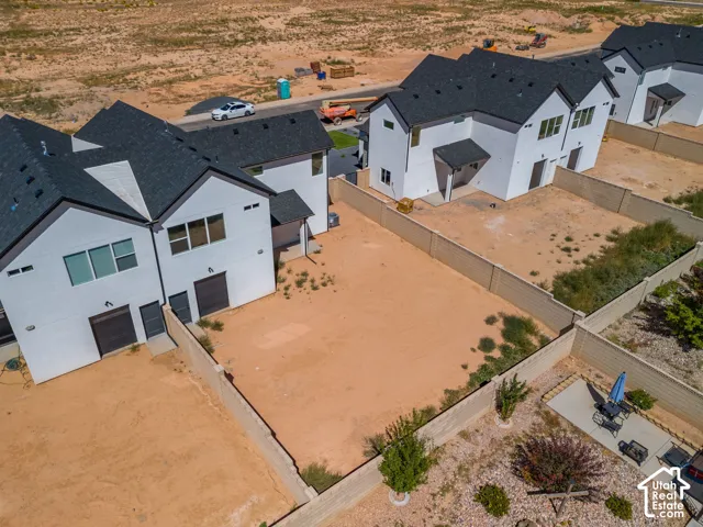 Modern architectural design with a white exterior finish, dark roofing, and attached garages