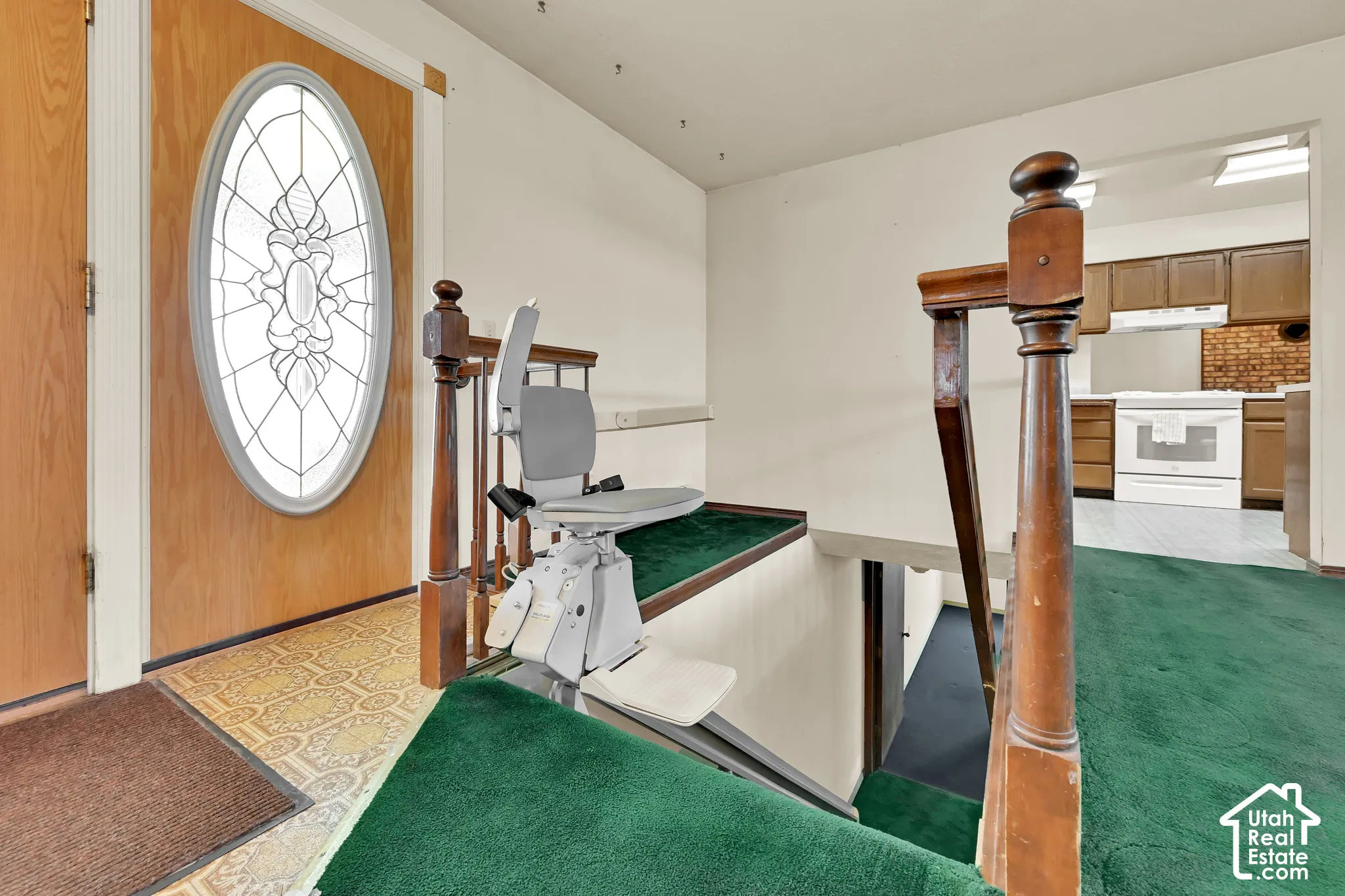 Entryway featuring a wood-panel door with decorative oval glass insert