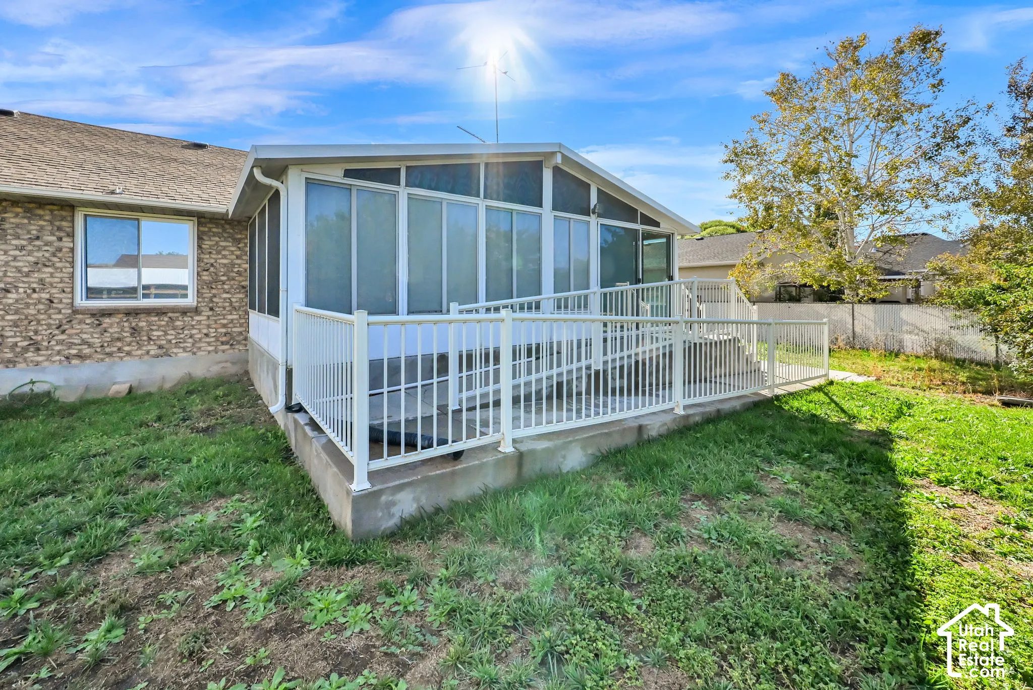 Enclosed patio with full wall screening, white railing, and an integrated access ramp
