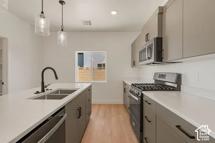 Kitchen featuring a stainless steel gas range, microwave, and dishwasher