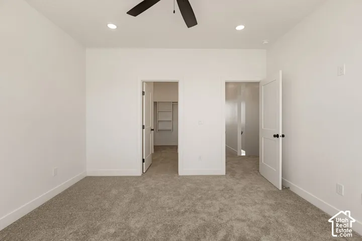 Recessed lighting, ceiling fan, and plush carpeting