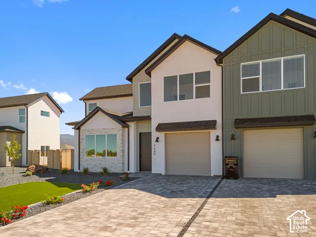 Contemporary exterior featuring a combination of stucco and board-and-batten siding