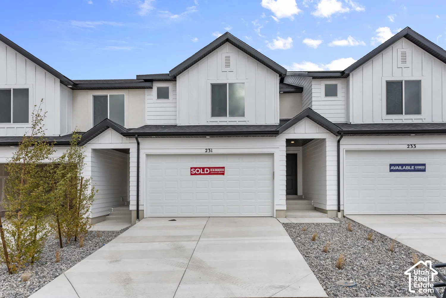 Contemporary exterior with white siding and dark trim