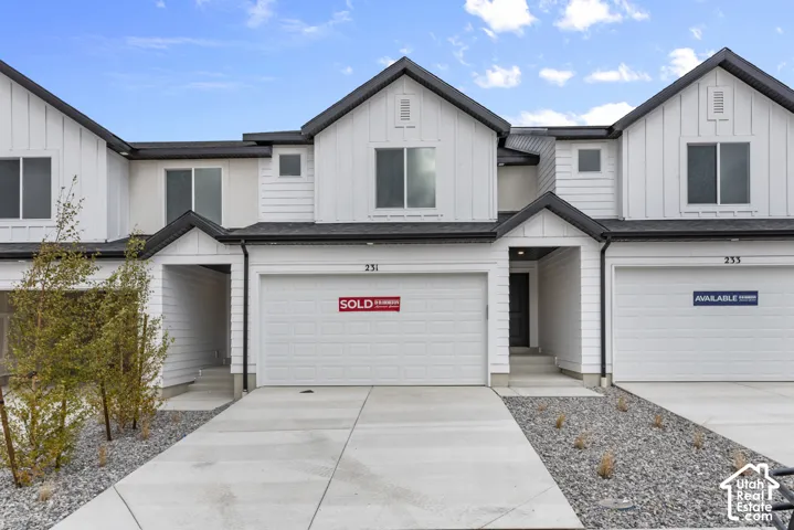 Contemporary exterior with white siding and dark trim