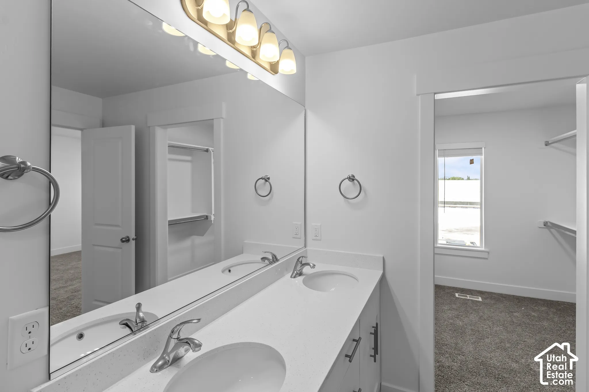 Dual basin vanity with an expansive mirror and a four-light fixture