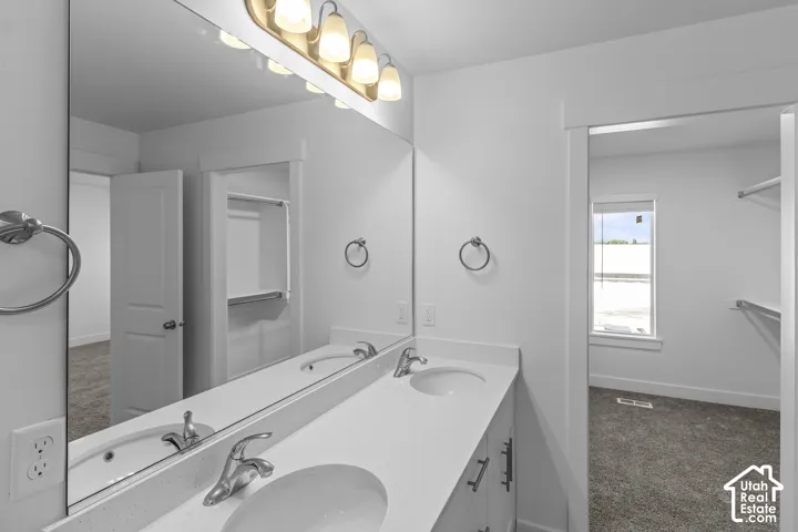 Dual basin vanity with an expansive mirror and a four-light fixture