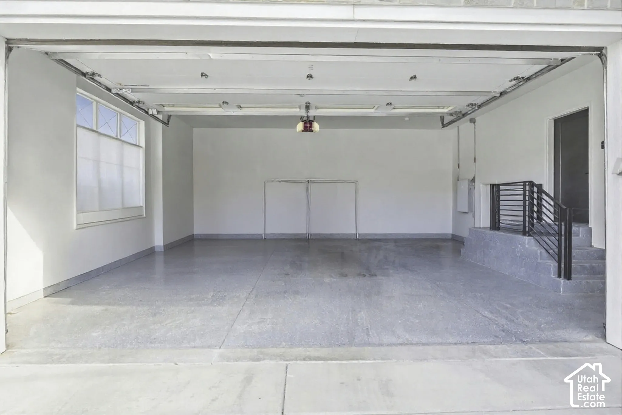 Spacious garage featuring a durable epoxy floor