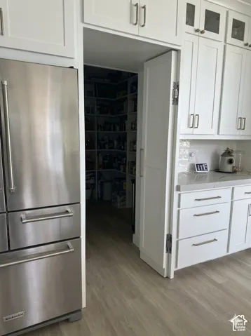 Hidden built-in pantry with shelving prep area and "Costco" door from garage