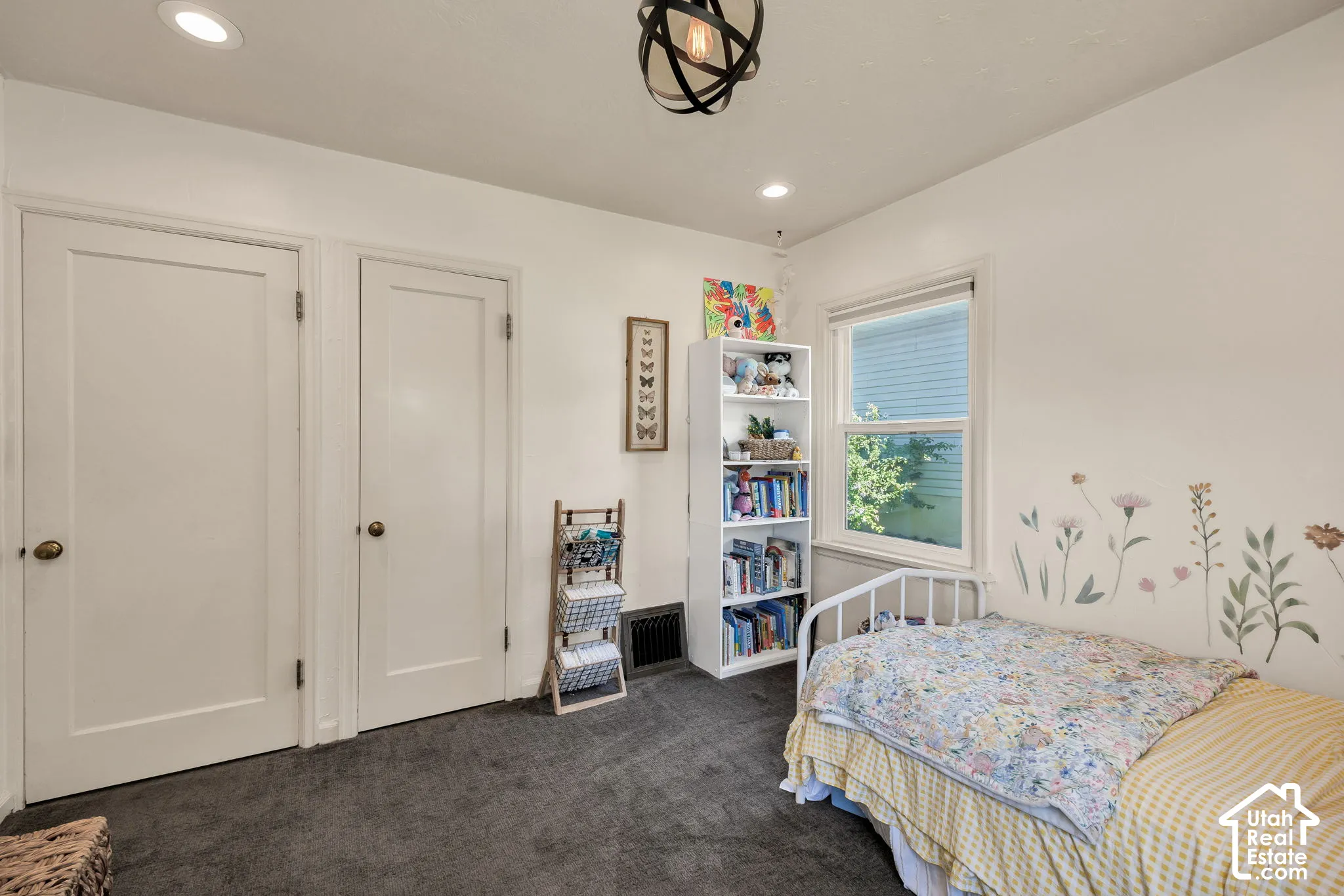 Recessed lighting, a ceiling-mounted light fixture, white interior doors, and a window with blinds