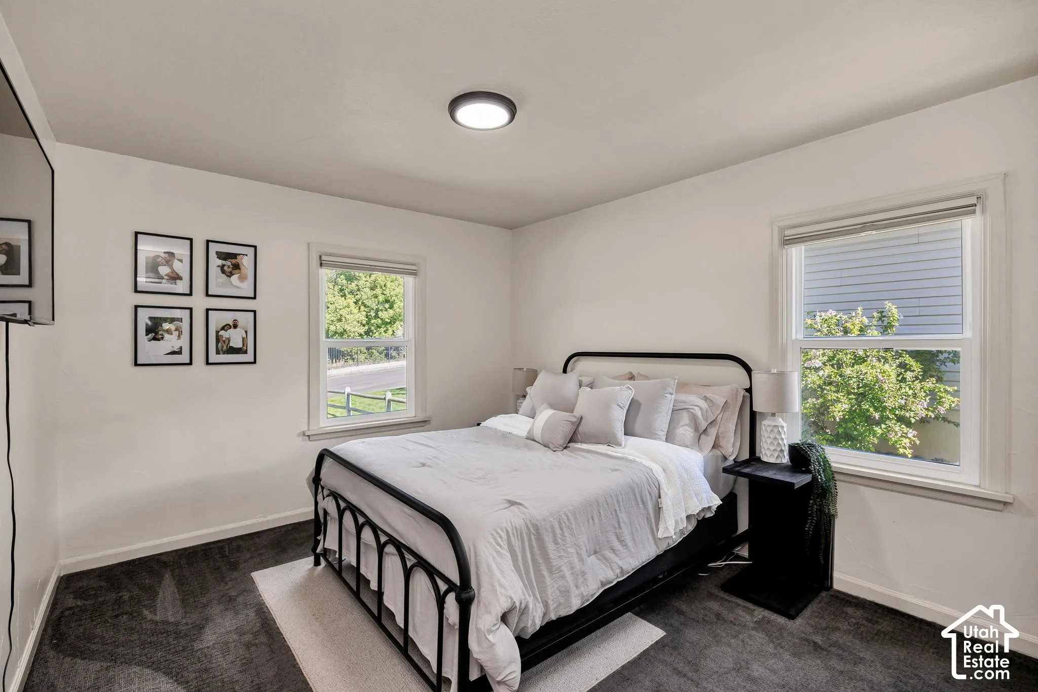 Main bedroom, White walls, recessed lighting, and dark carpet flooring.