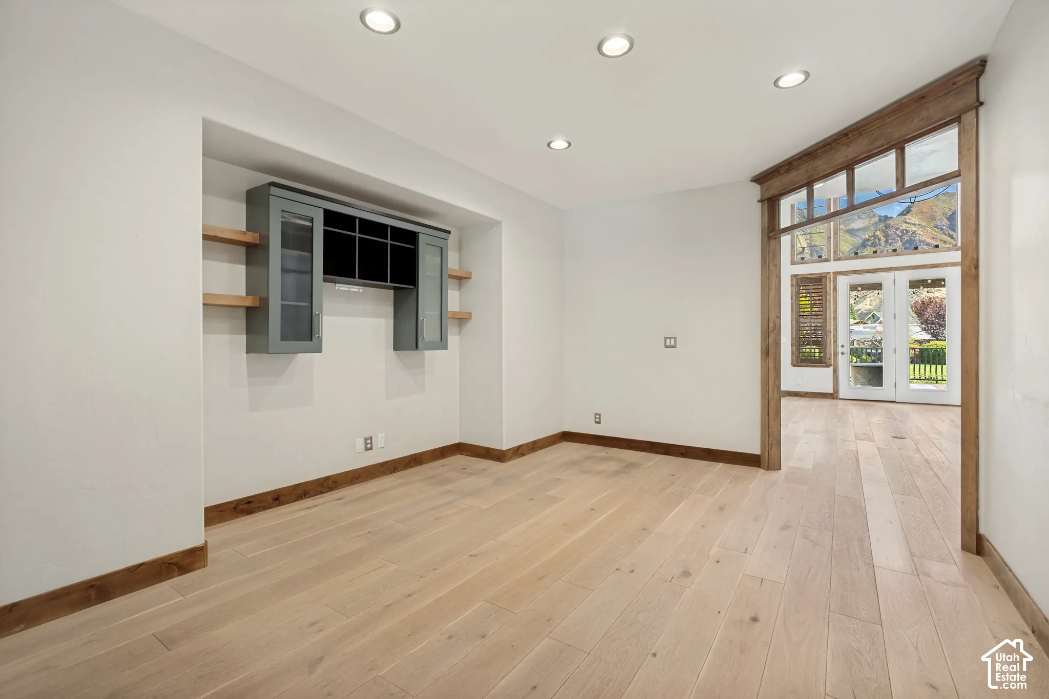 Recessed wall niche with built-in cabinetry and floating wood shelves