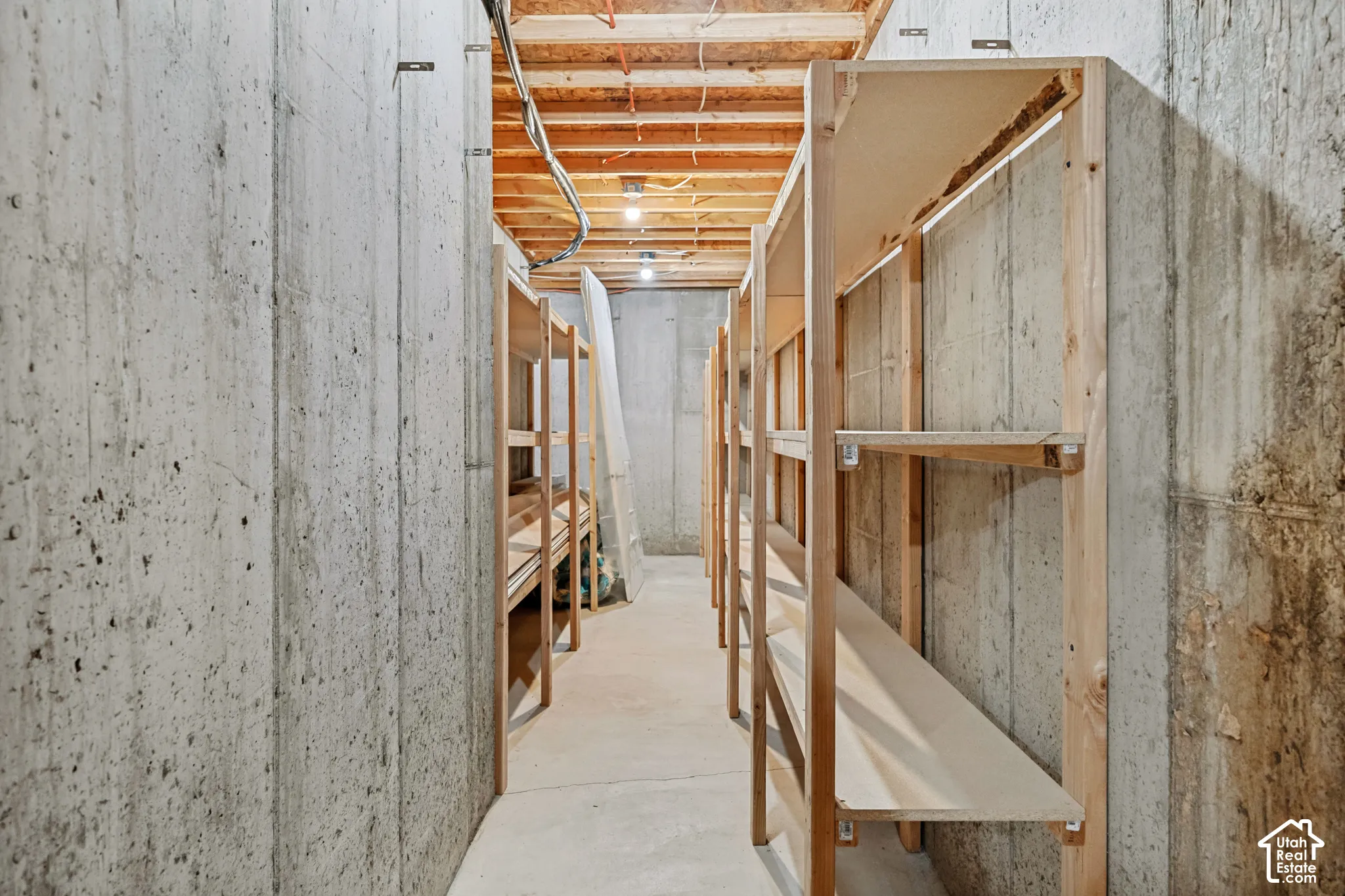 Concrete walls with built-in wooden shelving for storage
