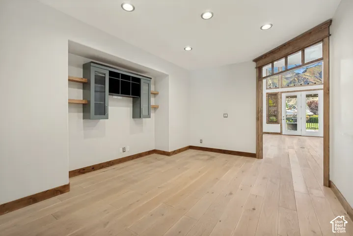 Recessed wall niche with built-in cabinetry and floating wood shelves