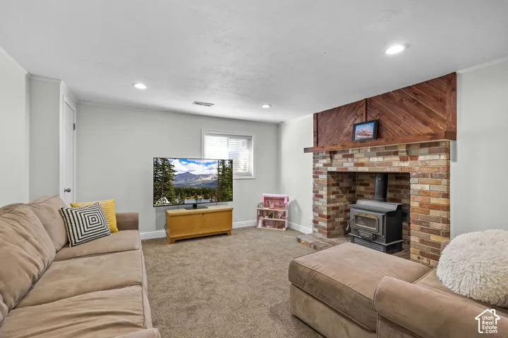 Brick fireplace with wood-burning stove and wood plank accent wall