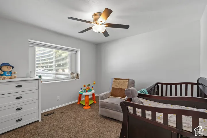 Recessed window with blinds, ceiling fan with integrated lighting, and neutral wall finishes