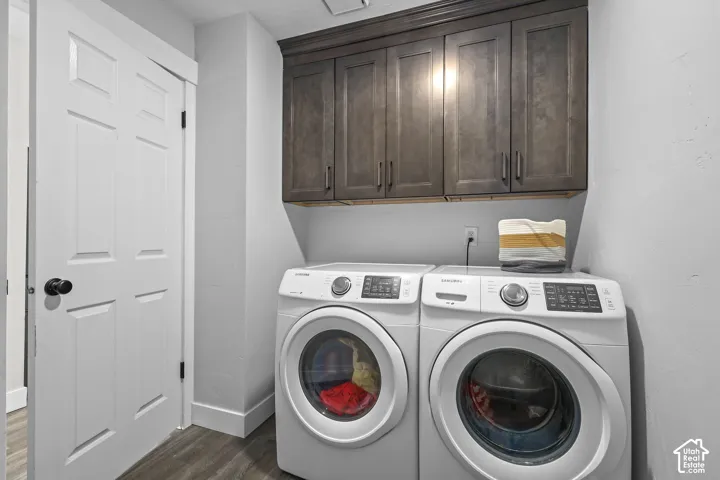 Wood-finish flooring with built-in upper cabinetry and a four-panel interior door