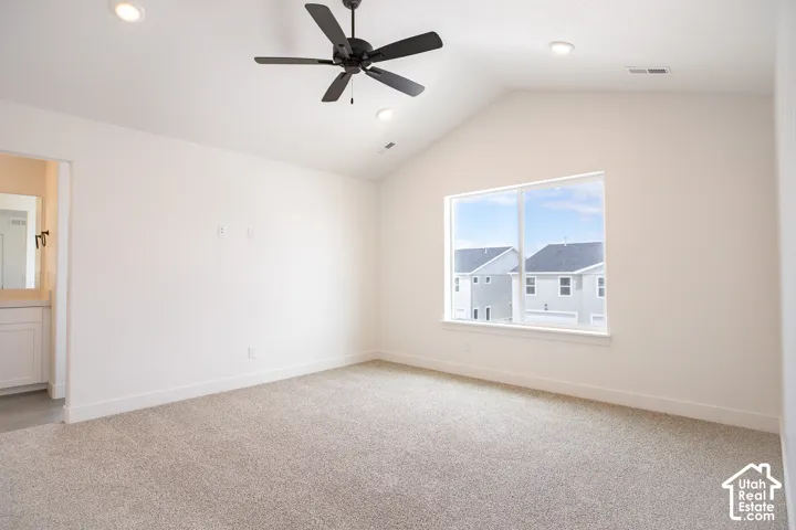 Primary bedroom with vaulted ceilings