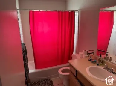 Bathroom featuring a built-in vanity with an integrated sink, a wall-mounted mirror, a toilet, and a shower-tub combination