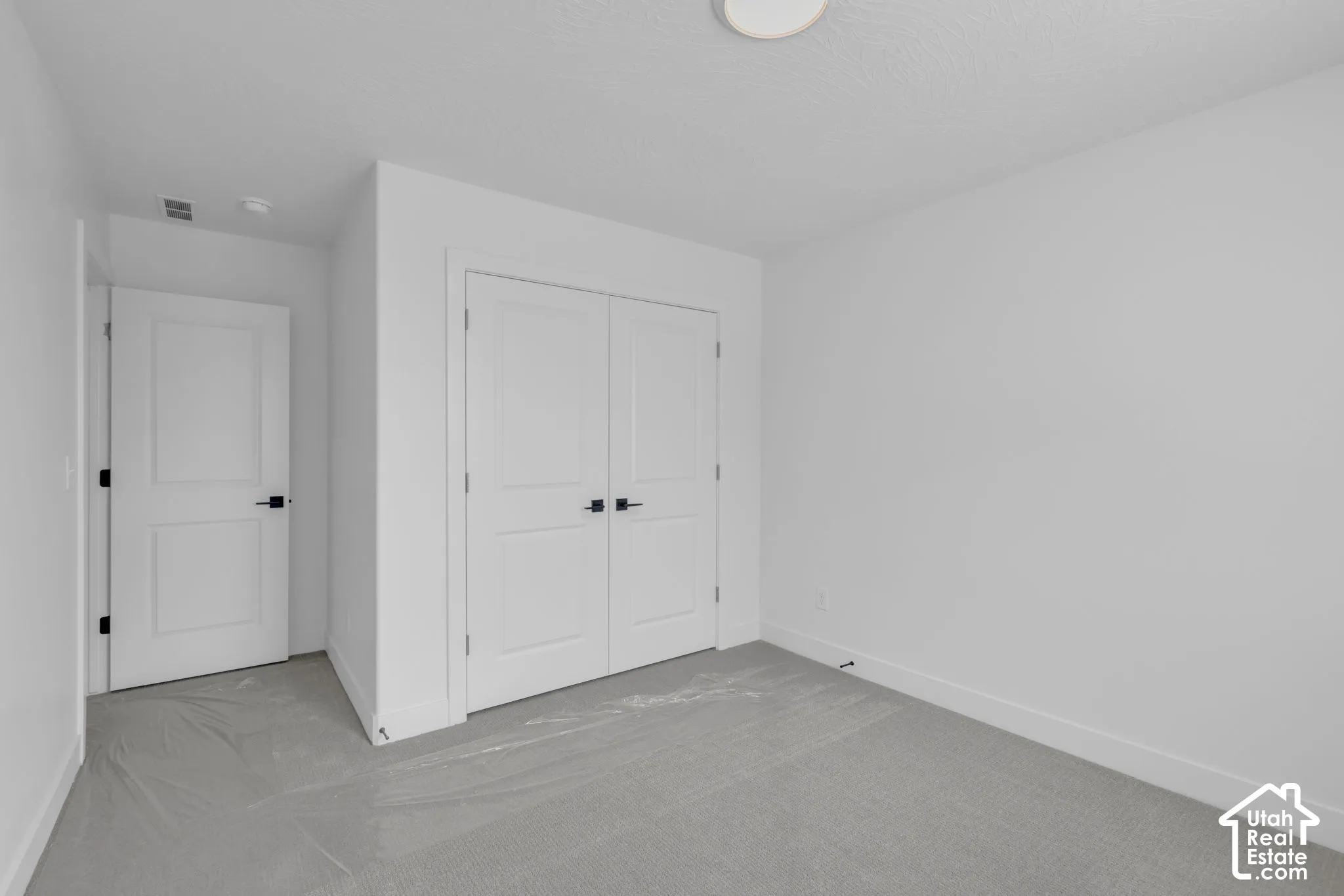Large oversized secondary bedroom with double door closet.
