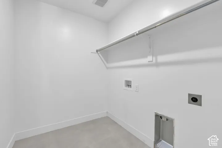 Dedicated large laundry room featuring tile flooring, and utility hookups.