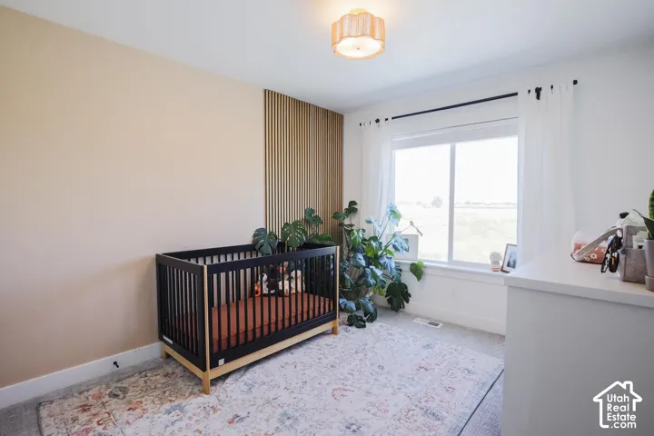 Recessed window with white trim, light-toned walls, and a wood-slat accent wall