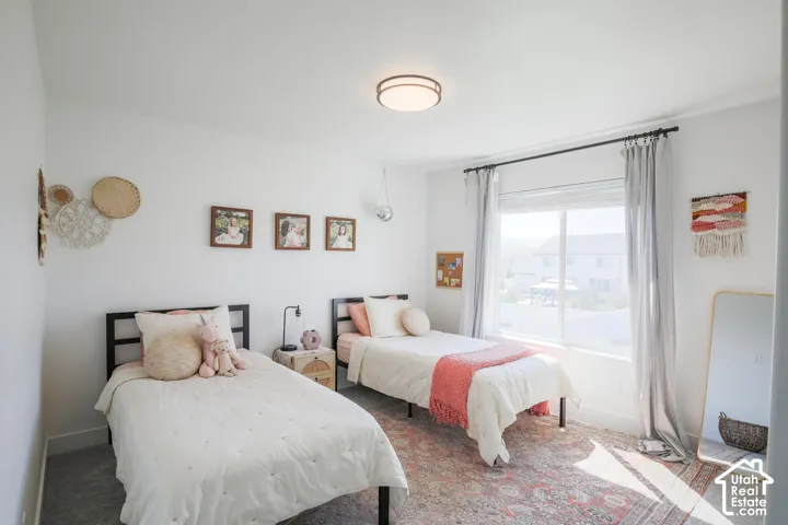 Bright interior lighting, large window with natural light, and plush carpeting