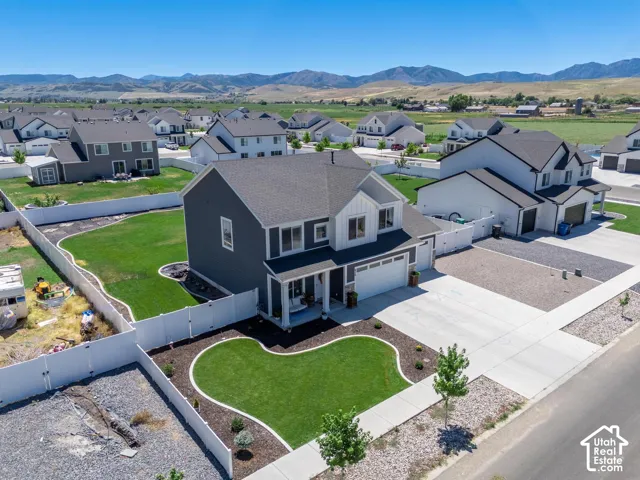 Two-story residence with a dark gray exterior and white trim accents